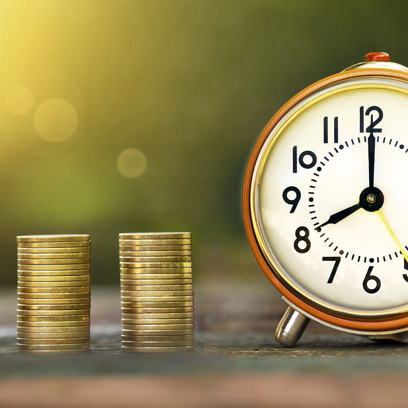 Golden coins and time - web banner of money savings concept